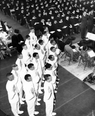 University of Idaho graduates watch as Navy R.O.T.C. men are commissioned during the University's commencement ceremony.
