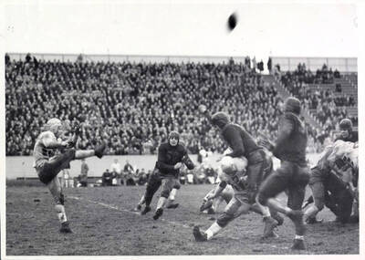 A kick of the football initiates several tackles during the Idaho vs. Montana football game that ended with a score of  19-6.