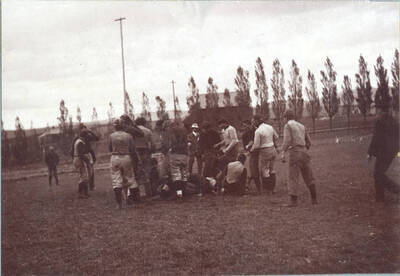 Football players stretch before getting ready to warm up for practice.