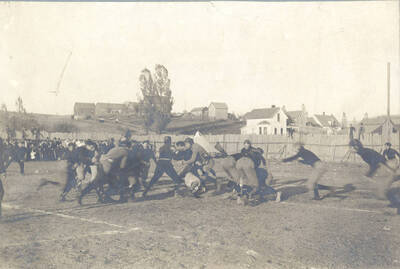 Several Idaho tacklers run to meet a Washington State runner before he reaches the goal-line.