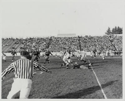 A Washington State receiver makes the catch and looks to avoid Idaho tacklers.