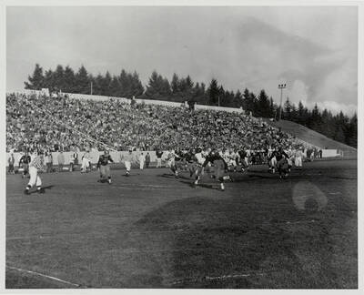 Two Idaho tacklers converge on a Washington State receiver.