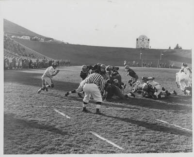 Several Idaho players converge for a scrum tackle.