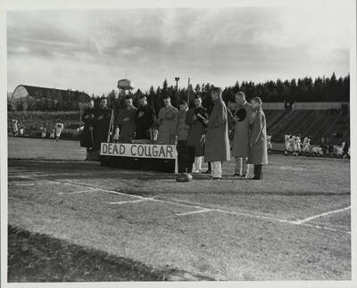 Another angle of Idaho fans sarcastically saluting the 'Dead Cougar' coffin. Players can be seen warming up in the background.