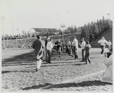 Introductions of the starting lineups. Number 66 takes the field between two lines of supporters.