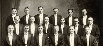 Portrait of the men's glee club. Identification from top left-bottom right: Norman D. Luvaas, Paul M. Harlan, Harry Brenn, Phillip Christen, E.F. Bradfield, Wayne Huddleson, Wesley A. Barton, J. Stanton McLaughlin, H.R. Allumbaugh, E.O. Bangs, Jesse Gray, Fred J. Carr, C. Warren Vickrey, Jefferson Rodgers, Werner Ripplinger, William Clyde WIlliams, Port Arthur, T. Byers Sayles.