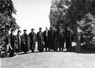 University of Idaho President Mevin G. Neale and Governor C. Ben Ross pose for a photograph with a group of unidentified individuals.