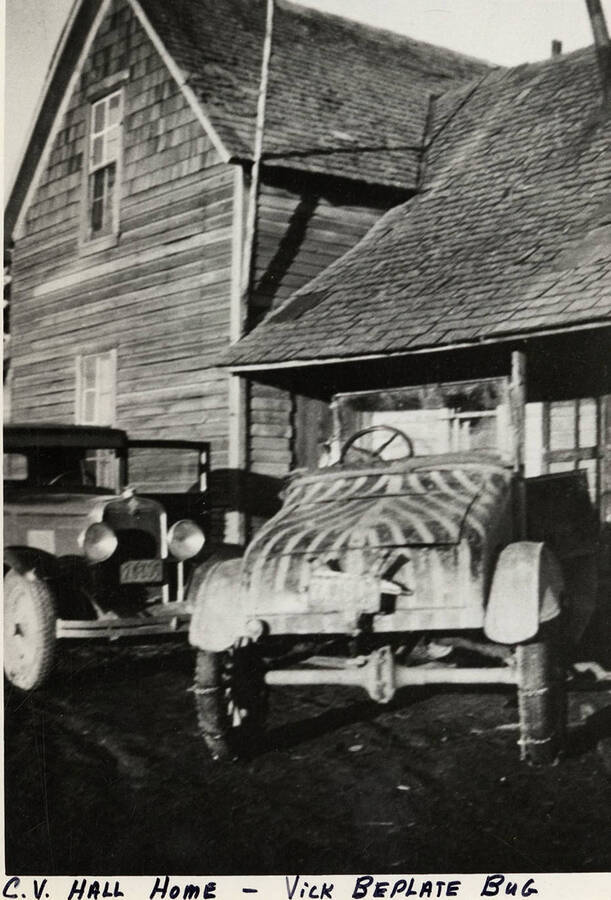 Vick Belplate's Bup and another vehicle parked outside the C. V. Hall Home.