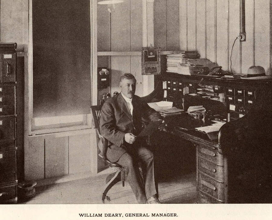 A photograph of William Deary, general manager, at his desk.