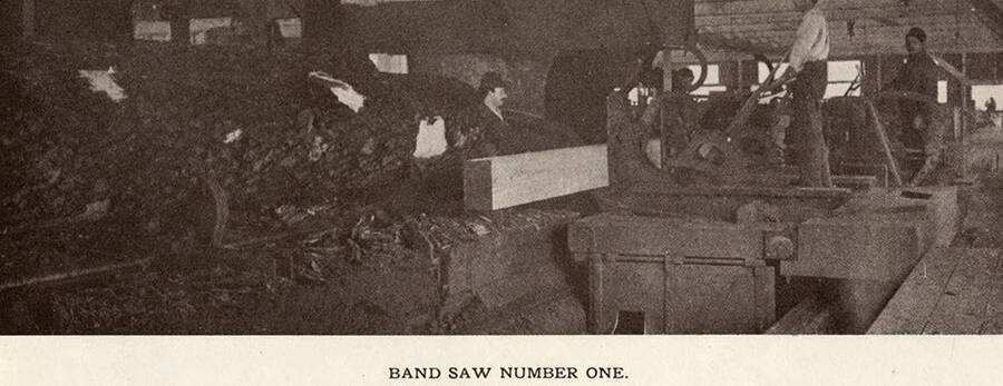 Employees working the Number One band saw at the sawmill.
