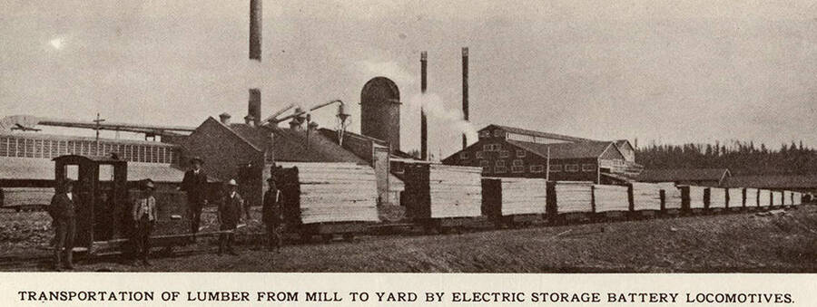 An electric storage battery locomotive transferring lumber from the mill to the yard.