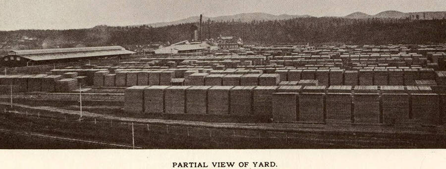 A partial view of a fairly full lumber yard.