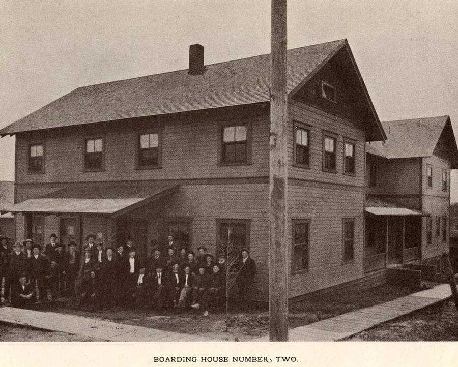 A photograph of boarding house number two with it's residents.