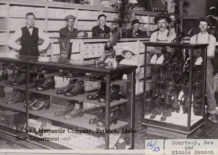 A photograph of employees and customers in the shoe department of the Potlatch Mercantile Company in Potlatch, Idaho.