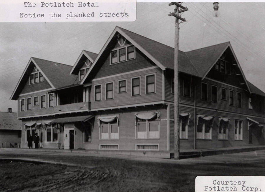 A photograph of the Potlatch Hotel and planked streets surrounding.