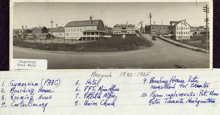 A photograph of buildings in Potlatch, Idaho. They are labeled as the rooming house, boarding house, boarding house later remodeled for theater, confectionary, gymnasium (PAAC), hotel, union church, Potlatch merc., PFI main office, and farm implements - Potlatch merc. later town site headquarters.