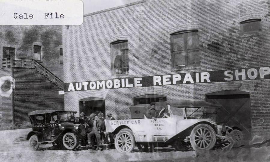 A photograph of the automobile repair shop, a service car, and a car being serviced.