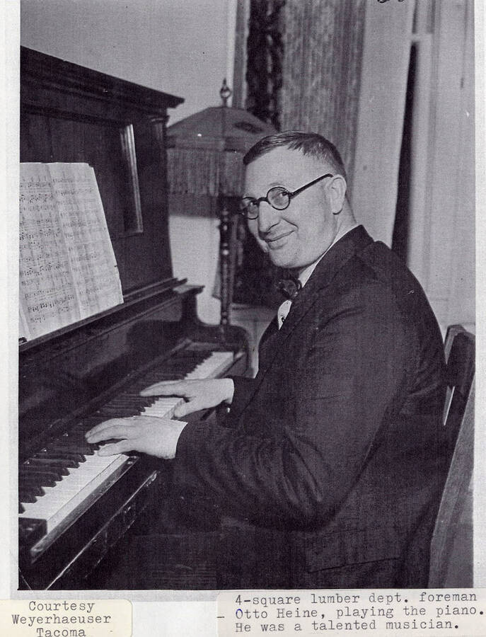 A photograph of Otto Heine, the 4-square lumber department foreman, playing the piano.