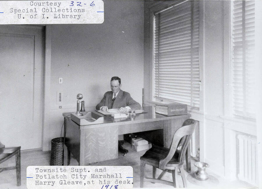 A photograph of Potlatch City Marshall and town site supt. Harry Gleave at his desk.