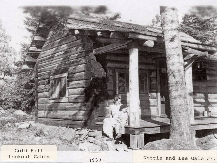 A photograph of the Gold Hill Lookout Cabin with Nettie and Lee Gale Jr.