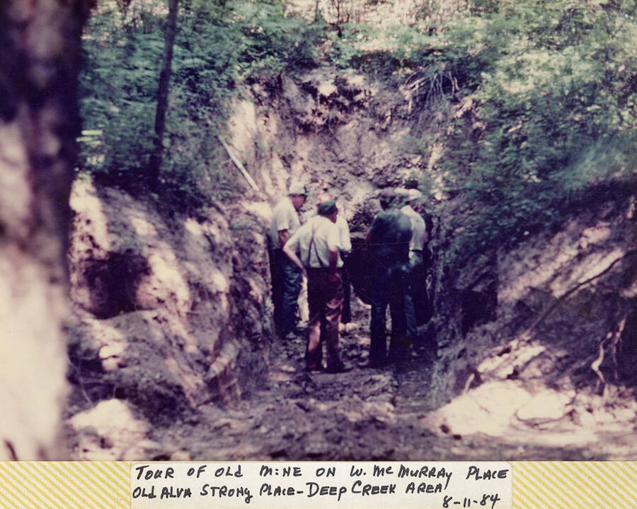 A group of people on a tour of the old mine on W. McMurray Place (old Alva Strong Place) in Deep Creek area Idaho.