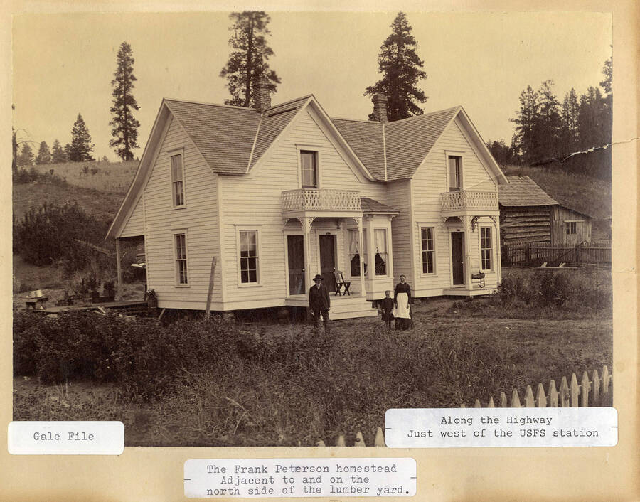A photograph of the homestead of Frank Peterson adjacent to and on the north side of the lumber yard along the highway west of the USFS station.