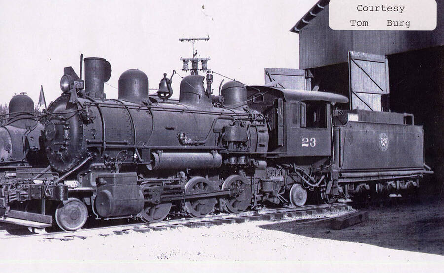 View of a No. 23 locomotive. The locomotive can be seen sitting just outside the doors of a building.