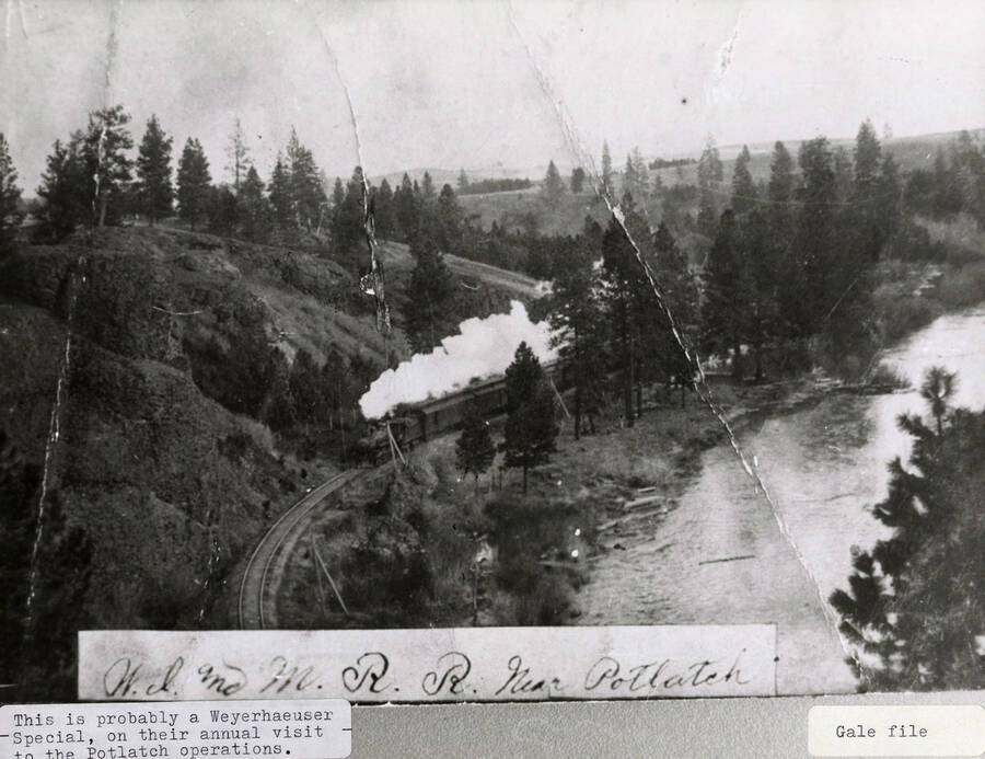 View of the WI&M railroad near Potlatch. A train can be seen on the railroad. This was probably a Weyerhaeuser Special, on their annual visit to the Potlatch operations.