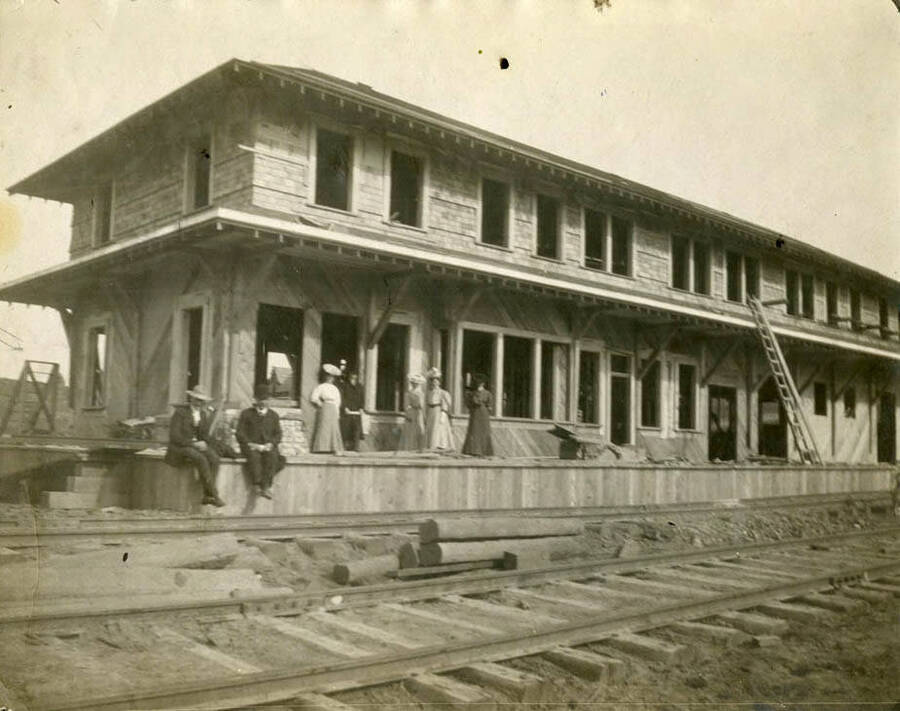 The Washington, Idaho & Montana railroad depot during its construction. Freshly laid tracks can be seen in front of the depot.