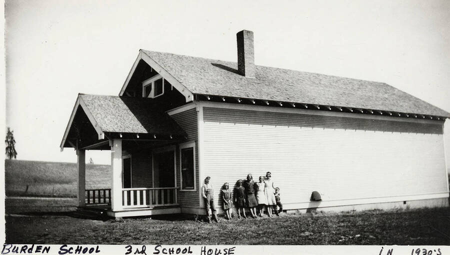 Several students are line up on the side of the Burden School, 3rd school house.  Photograph taken in the 1930's.