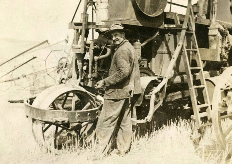 Robert W. McKown stands beside his self-propelling combine. It was the first and only self-propelling in the region at the time.