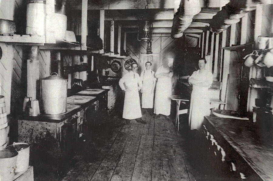 The cooking crew standing in the kitchen at one of the Potlatch camps.
