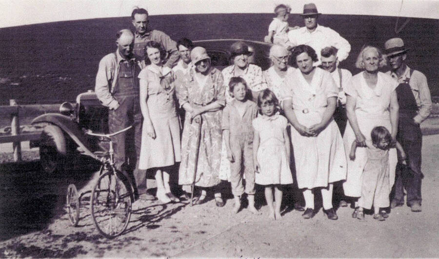 Family photo in front of car and with bicycle