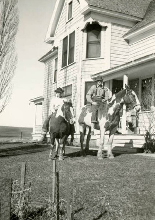 Roy and Max Davis on horseback at the Bean house at Yellow Dog