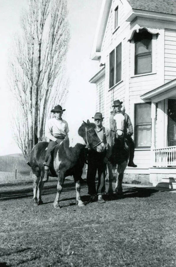 Roy and Max Davis and Sonny McMasters on horseback at the Bean home.
