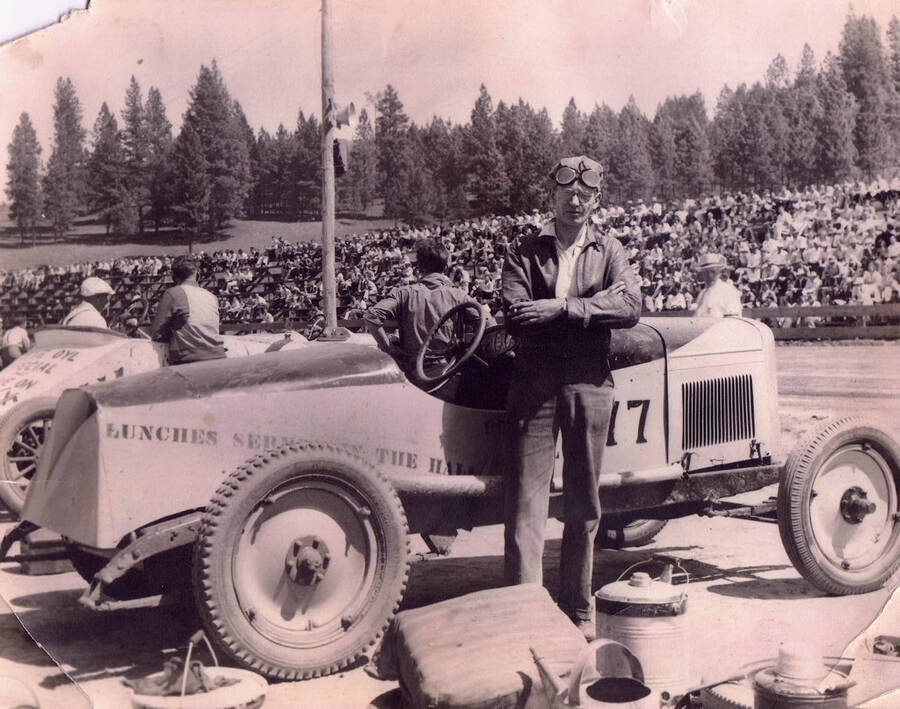 Lyle Gottschalk stands beside car #77 before the Riverside Races