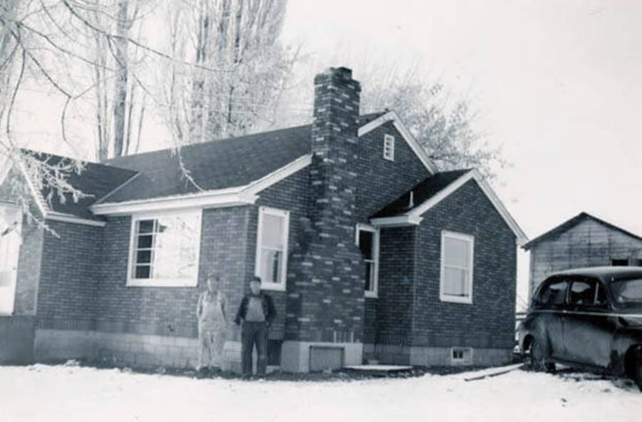 Two Davis men standing in front of a home on Duffield Flats Road owned by Grais and Crete Davis.