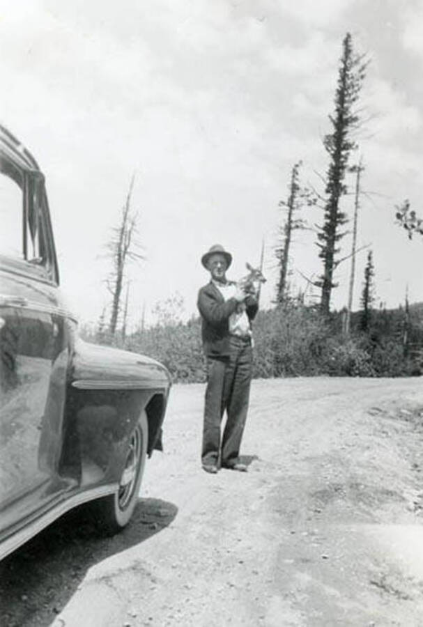 Roy Davis holding a fawn on Mt. Spokane
