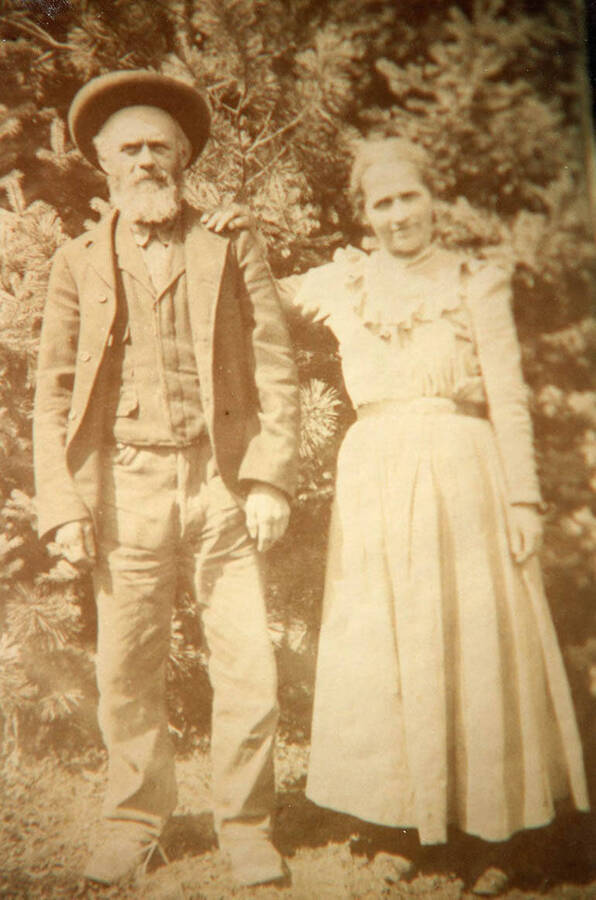 Gotfried and Anna Bysegger pose for a photograph in front of some trees.