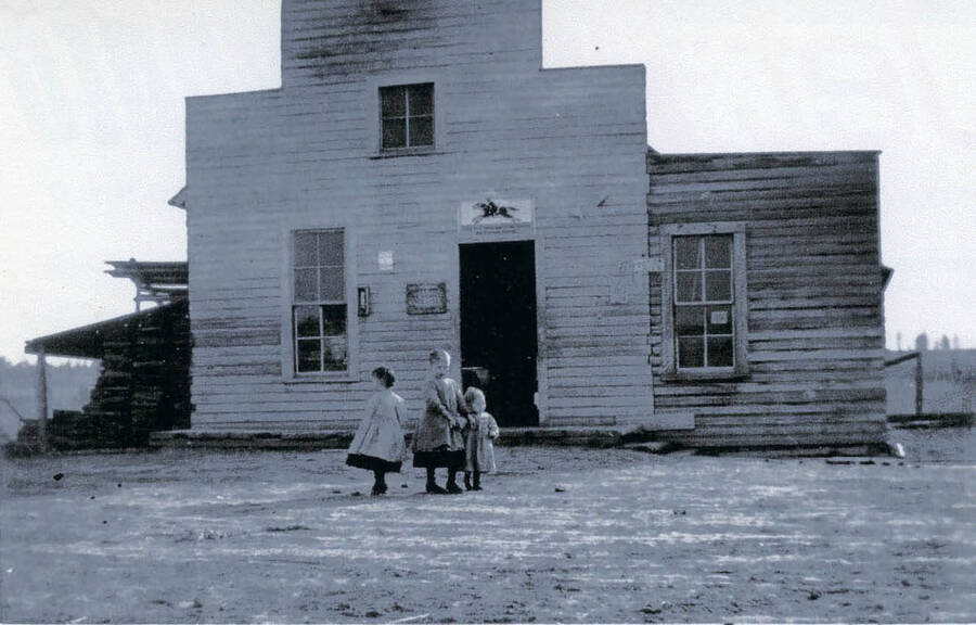 View of the Isabel Starner Store at Freeze, Idaho. Three children are standing in front of the store. The store was built in 1898 and was burned down in 1908.