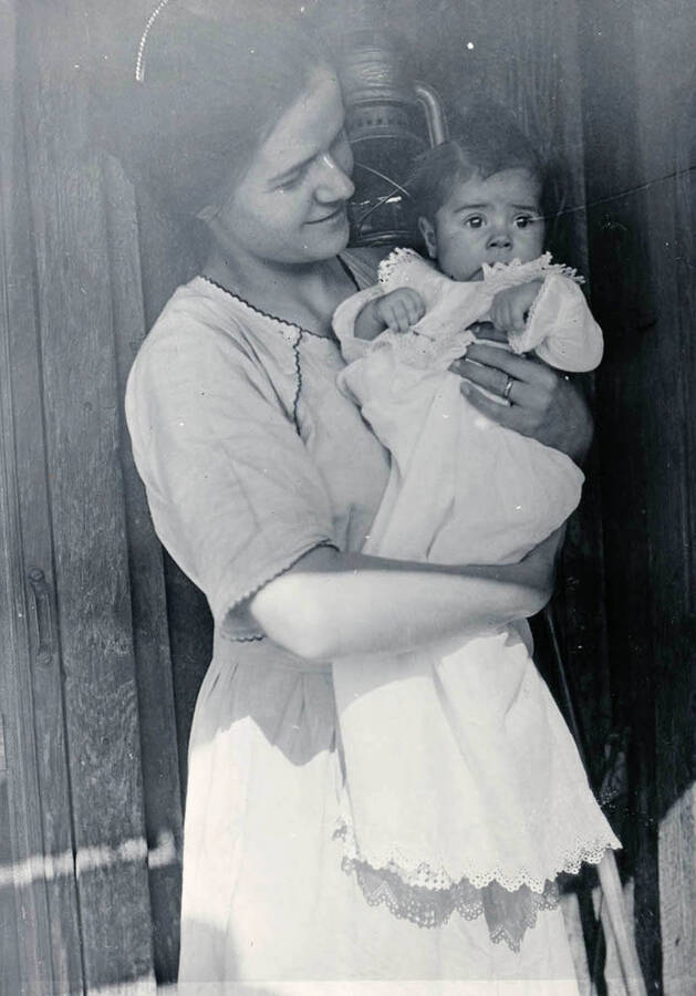Mary Bysegger Nirk holds daughter Cleora Anna outside the Bysegger homestead.