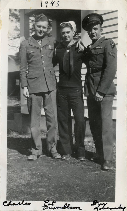 Charles King, Pat Bryngelson, Don Kobrosky (left to right) in front of house in military uniforms