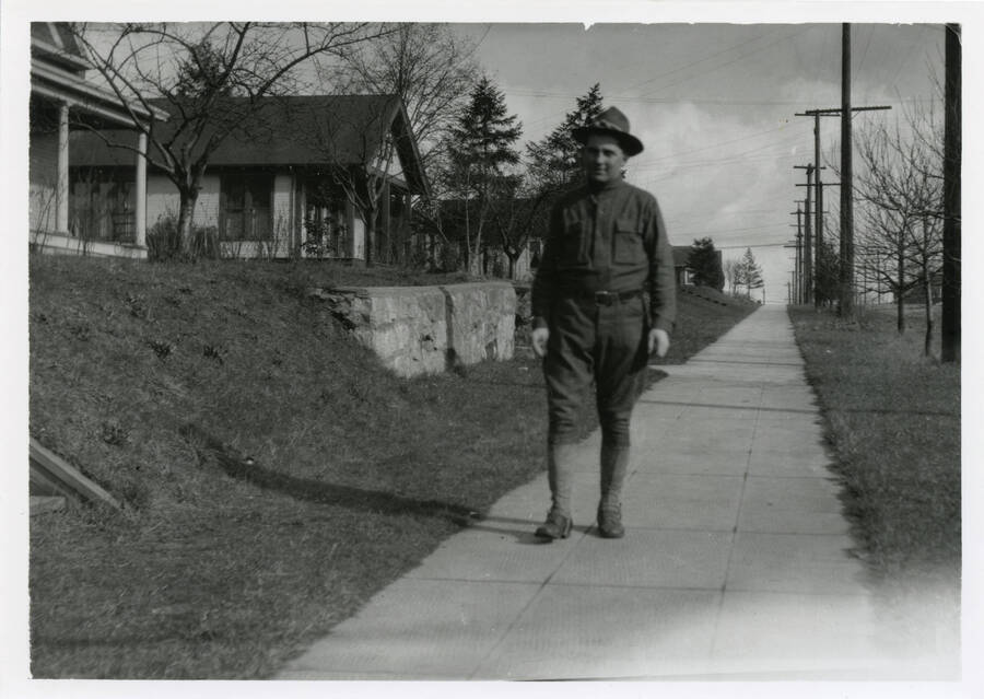 Photo of Durell Nirk on sidewalk in front of military base