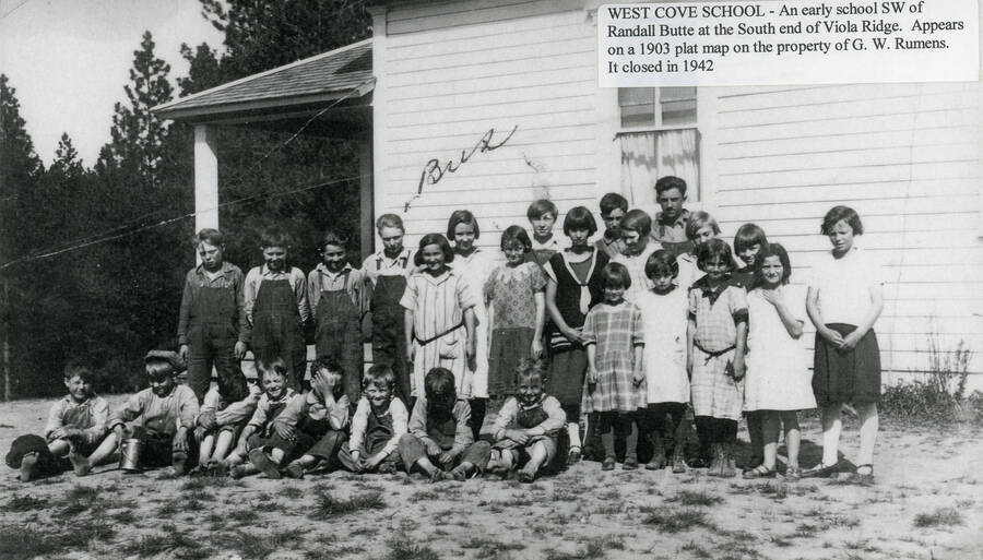 Children pose for a class photo at the West Cove School. This was an early school southwest of Randall Butte at the south end of Viola Ridge. It appears on a 1903 plat map on the property of G.W. Rumens. The school was closed in 1942.