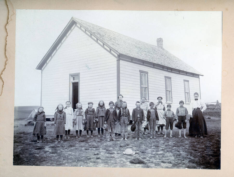 Teacher Millie Lynd Patterson with students in front of a school near Potlatch, Idaho.