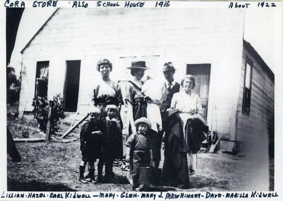 The Cora Store, built in 1916, also functioned as the schoolhouse. The people in the photo are: Lillian, Hazel, and Earl Kidwell; Mary, Glen, and Mary J. Mewhinney; and Dave and Marilla Kidwell. 