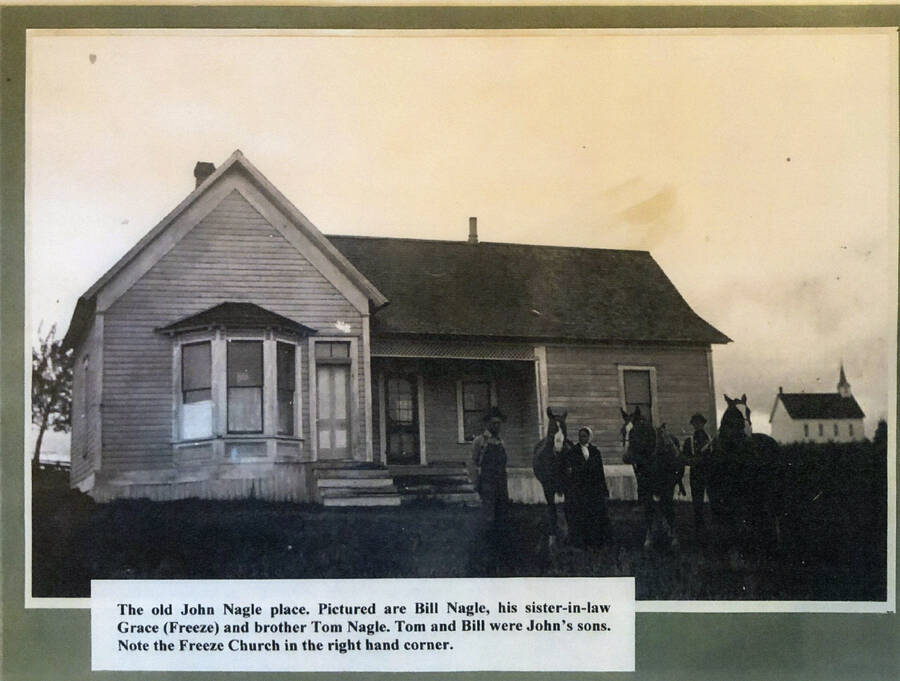 The John Nagle home with Bill Nagle, Grace (Freeze) Nagle and Tom Nagle with their horses. The Freeze Church is visible in the background on the far right.
