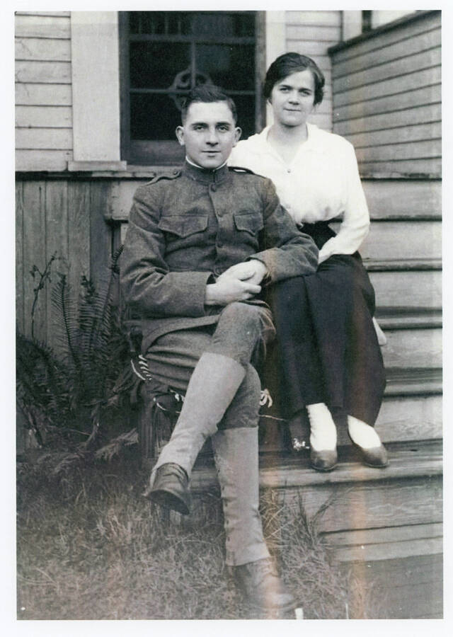 Durrel and Mary Nirk pose for a photo in front of their home.