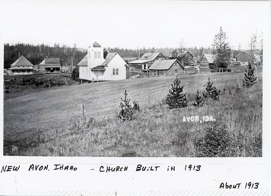 Some of the buildings in New Avon, Idaho featuring the church (white building at center left) that was built in 1913.