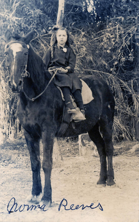 A young Norma Reeves poses on horseback for a photograph.